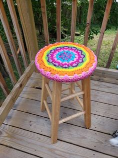 a stool made out of crocheted yarn sitting on a deck