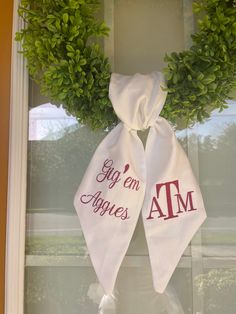 two green wreaths on top of a window sill with the words i'm and am printed on them