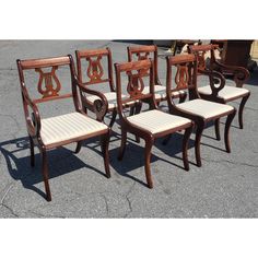 six chairs are lined up on the pavement