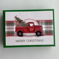 a red truck with a christmas tree in the back and merry lettering on the front