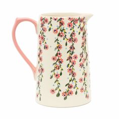 a white and pink mug with flowers on the inside, sitting against a white background