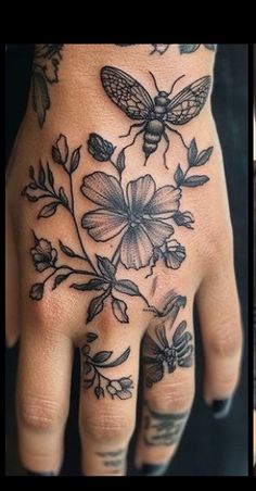 two pictures of different tattoos on hands and one with a bee, flowers and leaves