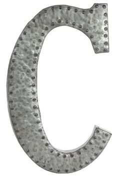 the letter c is made out of metal with rivets and dots on it