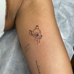 a small tattoo on the arm of a woman