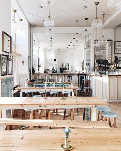 an empty restaurant with wooden tables and benches