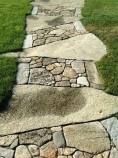 an image of a stone path going through the grass