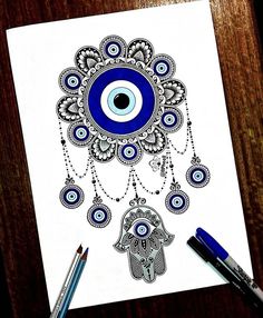 a drawing of an evil eye and hamsah with beads hanging from it's eyes