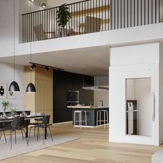 an open concept living and dining area with wood flooring, white walls, black furniture and large windows