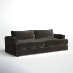 a black couch sitting on top of a white floor