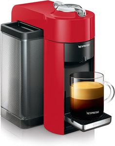 a red coffee maker next to a cup of coffee