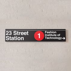 there is a sign on the wall that says 23 street station 1 fashion institute of technology