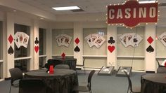 a casino themed room with tables and chairs