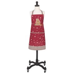 a red apron on a mannequin with an image of a gingerbread house