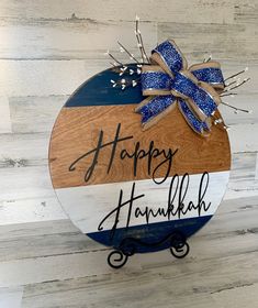 a happy hanukkah sign with a blue bow on it's side