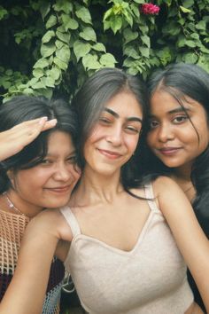 three women are posing for the camera with their arms around each other