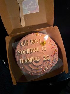 a birthday cake in a box with the message oh no someone is turning 20