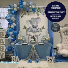 an elephant themed baby shower with blue and silver balloons on the wall, table set up for it's first birthday