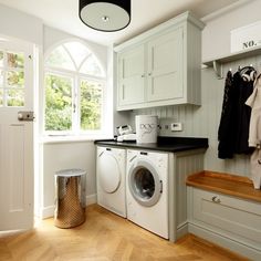 a washer and dryer in a room with wood flooring on the ground