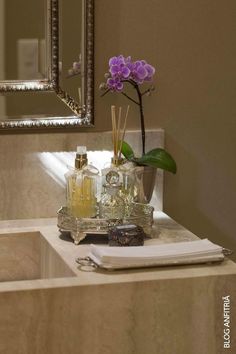 an instagram photo with flowers and perfume bottles on a table in front of a mirror