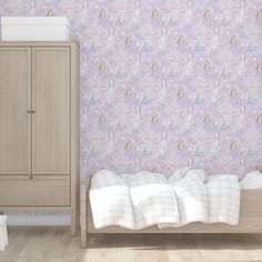 a bedroom scene with focus on the bed and wallpaper that has unicorns on it