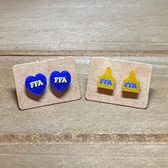 These are our new, FFA Glitter Stud Earrings!  You are purchasing ONE set of our FFA Inspired Earrings in your choice of style, either Heart, Ear Tag, or if you can't decide, BOTH! Here are the details: -Glitter FFA Earrings in two designs! Choose either our Blue Glitter Hearts or our Gold Ear Tag studs.  Can't decide? choose the BOTH Pairs options!  -These make a wonderful gift for friends, family, and students who have close ties to the FFA Community or those who are past or current participants in the program.   -See photos for measurements of each of the different shapes.  -Fitted with nickel and lead free stud posts and rubber backs for comfort. May be substituted for lead and nickel free silver backs depending on what we currently have in stock.  -In order to preserve your new jewelr Glitter Stud Earrings, Ear Tag, Ffa, Glitter Hearts, Blue Glitter, One Set, Different Shapes, Heart Earrings, Jewelry Earrings Studs