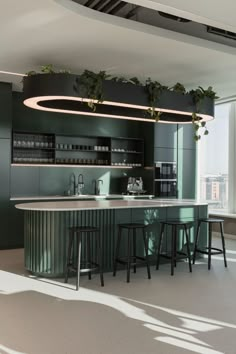 a kitchen with green cabinets and bar stools