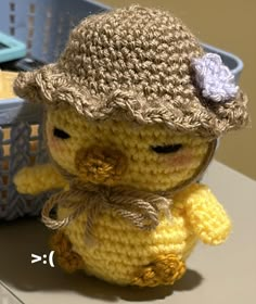 a small crocheted stuffed animal wearing a hat