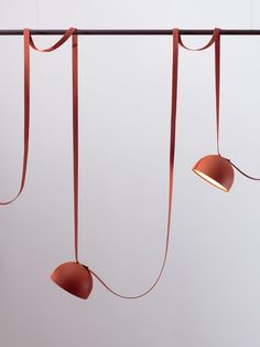 three lamps are hanging from a long cord