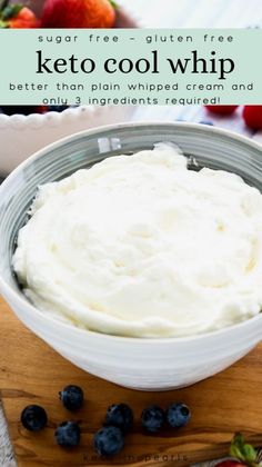 a bowl of keto cool whip with blueberries and strawberries in the background