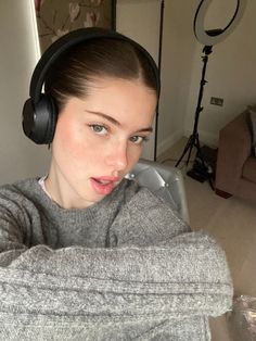 a woman with headphones on taking a selfie