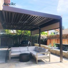 an outdoor living area with couches and tables