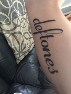 a person with a tattoo on their arm that says hope and the word hope is written in cursive black ink