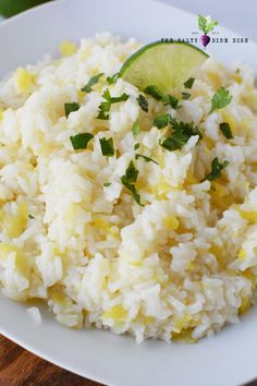 white rice with lime and cilantro served on a white plate, ready to be eaten