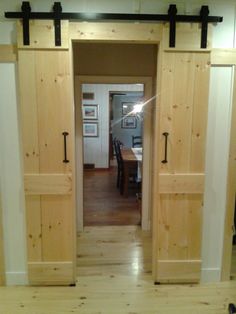 an open door leading to a kitchen and dining room