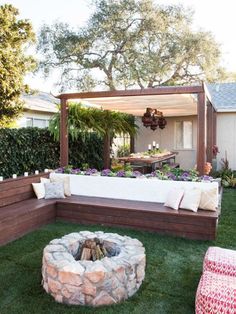 a backyard with a fire pit and seating area