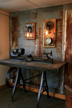 an old fashioned sewing machine sits on top of a table in front of two mirrors