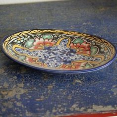 a blue and yellow plate sitting on top of a table