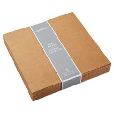 a stack of brown notebooks with a ribbon on the front and back covers in grey