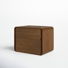 a small wooden box sitting on top of a white surface with no one around it