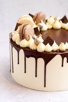 a close up of a cake with chocolate icing and cookies on the top,