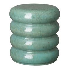 a green stool with four stacked sections on top