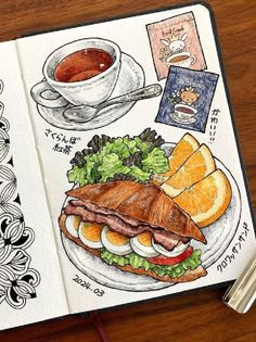 an open notebook with some food on it and a cup of coffee next to it