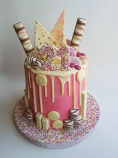 a birthday cake decorated with sprinkles and candies