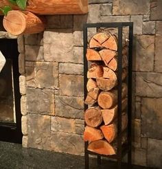 a stack of logs sitting next to a fire place