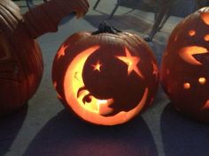 two pumpkins with faces carved into them