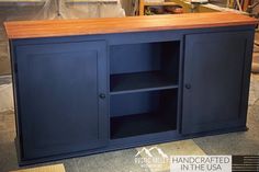 a large blue cabinet sitting on top of a floor next to a wooden countertop