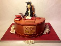 a cake made to look like a judge's desk with a lady justice figure on top