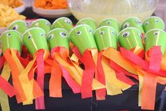 there are many green and orange items on the table with streamers in front of them