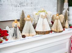 christmas decorations are sitting on top of a mantle