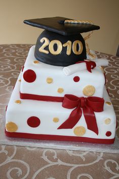 a graduation cake with a hat on top